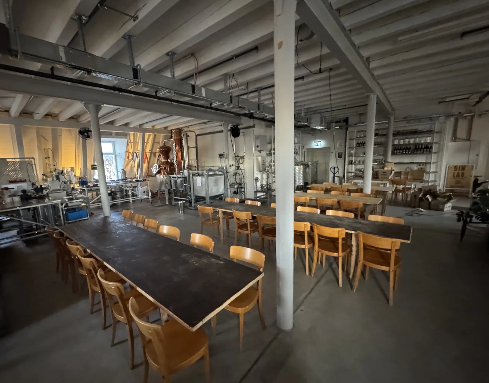 The GIN LAB. distillery in the Aktienmühle in Basel, seated for 40 people at two long tables, the Holstein still behind